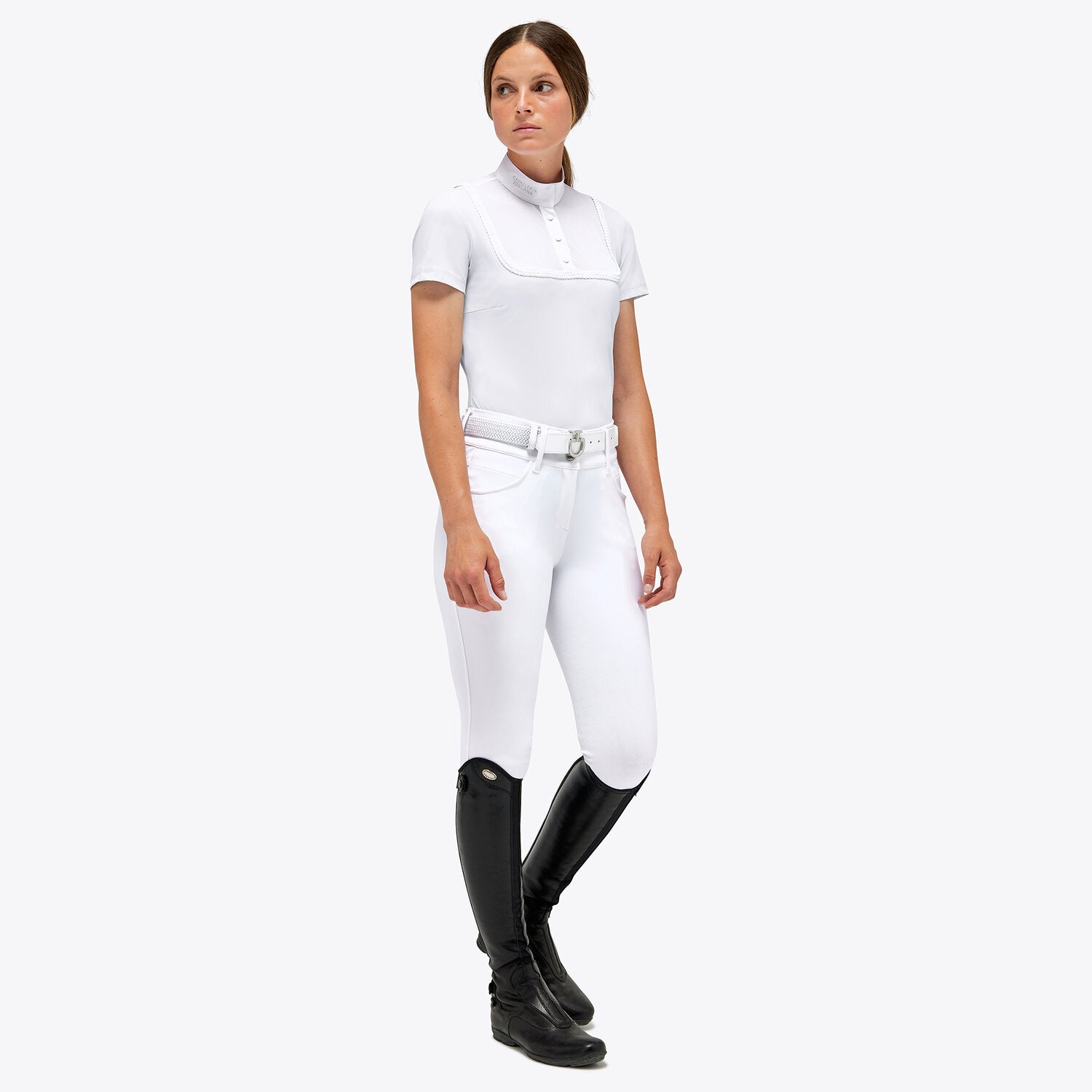 Person wearing a white CAVALLERIA TOSCANA equestrian outfit with black boots on a white background